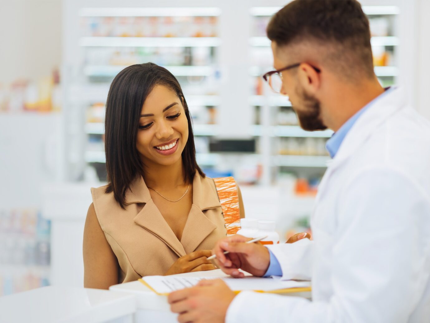 Pharmacist helping patient at pharmacy