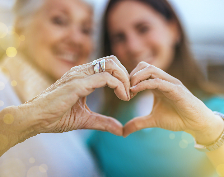 Two women making heart with their hands